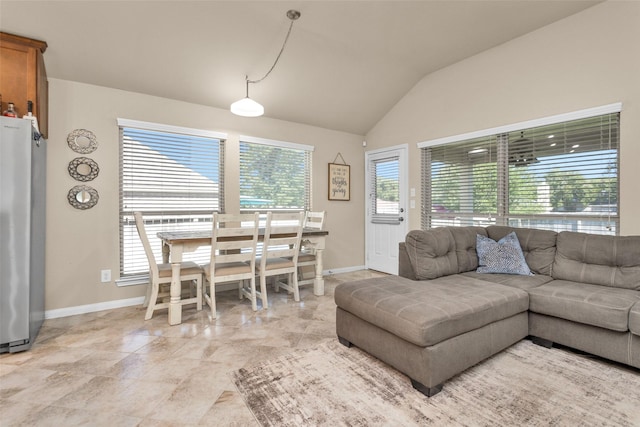 living room featuring a healthy amount of sunlight and lofted ceiling