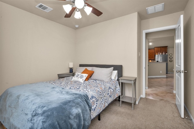 bedroom featuring stainless steel fridge, ceiling fan, and carpet floors