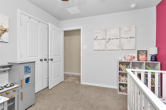 bedroom featuring ceiling fan, light colored carpet, and a closet