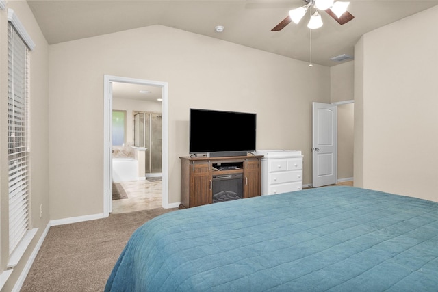 bedroom with connected bathroom, ceiling fan, light colored carpet, and lofted ceiling