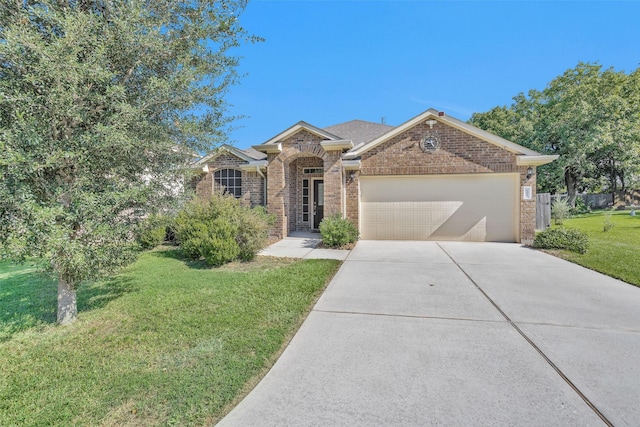 view of front of home featuring a garage and a front yard