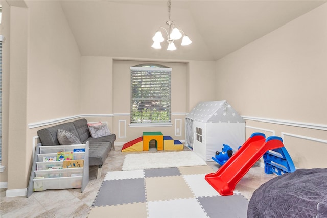 game room with vaulted ceiling and an inviting chandelier