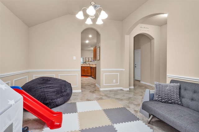 interior space featuring vaulted ceiling and a notable chandelier