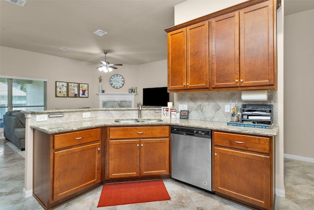 kitchen featuring sink, stainless steel dishwasher, ceiling fan, light stone countertops, and kitchen peninsula