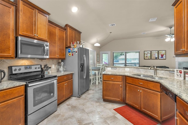 kitchen with sink, ceiling fan, appliances with stainless steel finishes, tasteful backsplash, and light stone counters