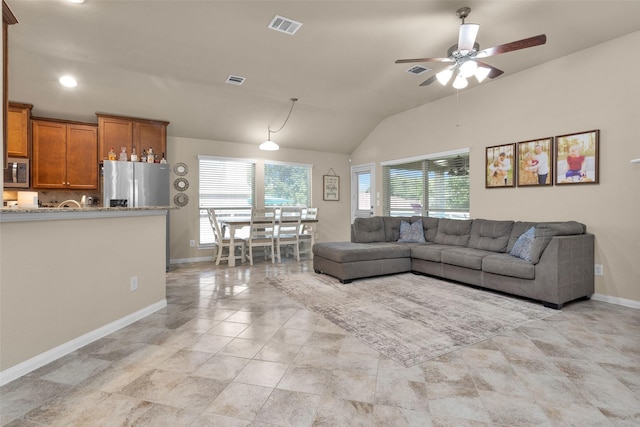 living room featuring ceiling fan and lofted ceiling