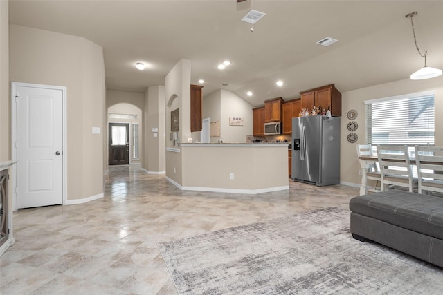 kitchen featuring kitchen peninsula, plenty of natural light, stainless steel appliances, and decorative light fixtures