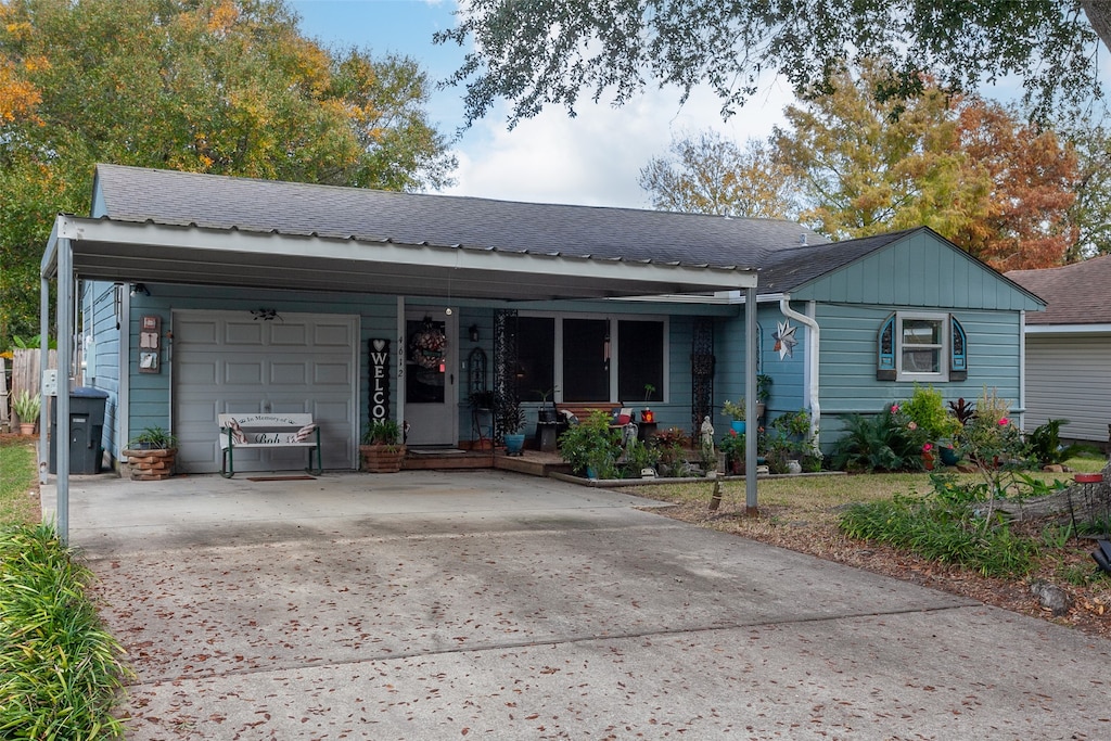 ranch-style house featuring covered porch and a garage