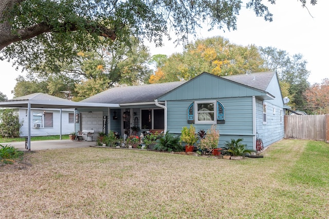 view of front facade with a carport and a front yard