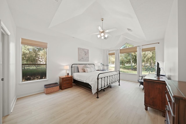 bedroom featuring vaulted ceiling, ceiling fan, and light wood-type flooring