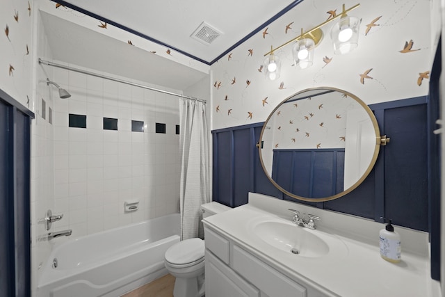 full bathroom with shower / tub combo with curtain, vanity, and toilet