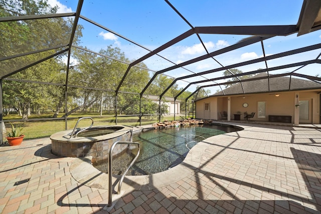 view of pool with an in ground hot tub, a patio, and glass enclosure