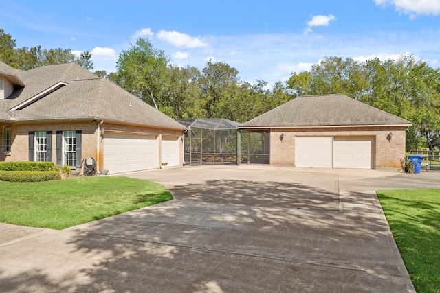 view of side of property featuring a lanai and a lawn