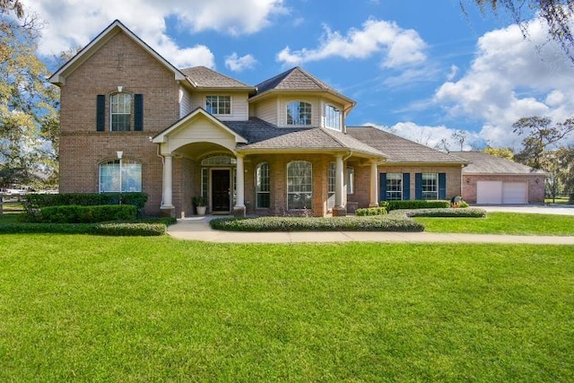 view of front of property with a garage and a front lawn