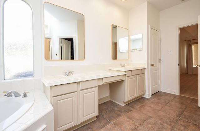 bathroom featuring vanity and a bath