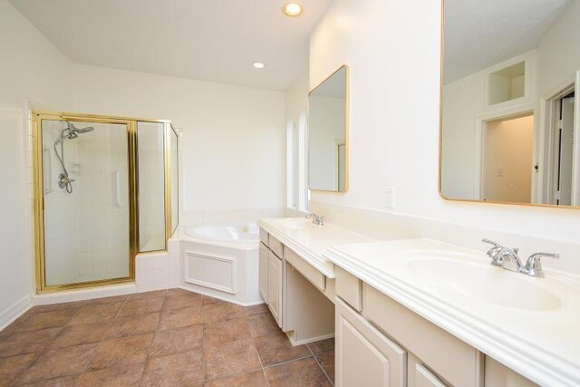 bathroom with vanity and shower with separate bathtub