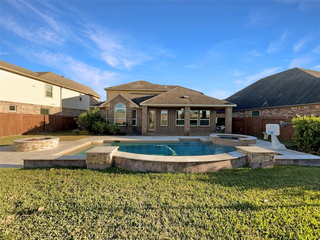 view of pool with an in ground hot tub, a fire pit, and a lawn