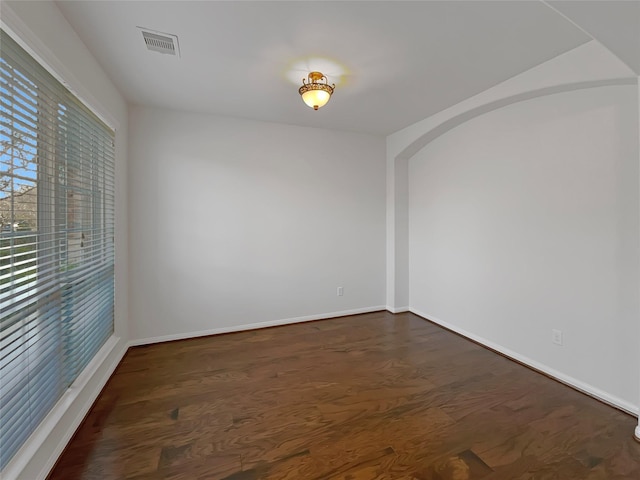 empty room featuring dark wood-type flooring