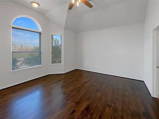 empty room with ceiling fan, dark hardwood / wood-style flooring, and lofted ceiling