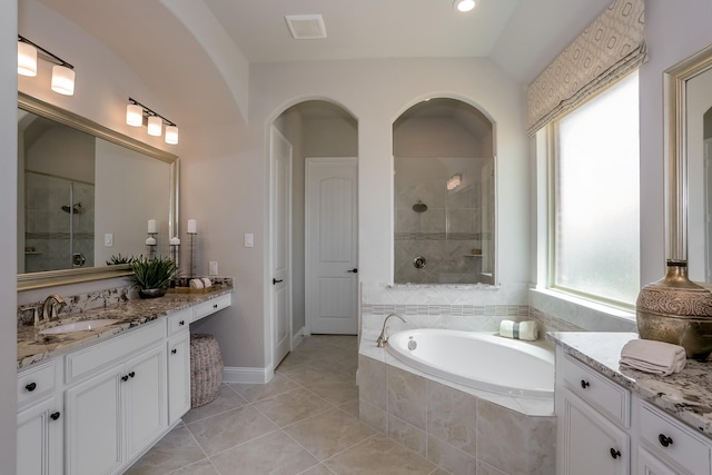 bathroom featuring tile patterned floors, a wealth of natural light, vanity, and shower with separate bathtub