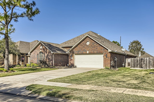 view of front of property featuring a garage and a front lawn