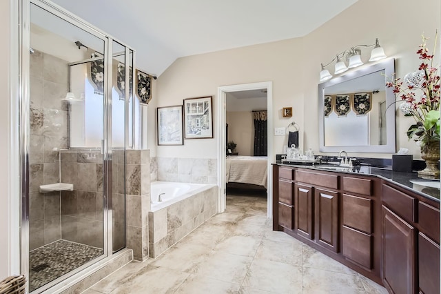 bathroom with lofted ceiling, ensuite bathroom, a shower stall, vanity, and a bath