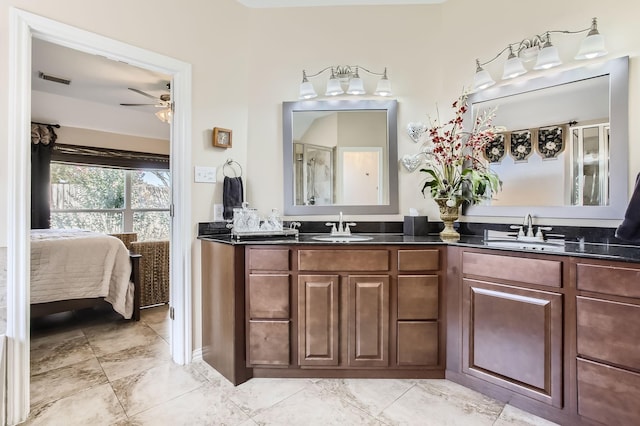 bathroom featuring double vanity, a ceiling fan, a sink, and ensuite bathroom