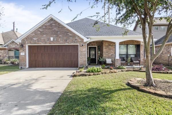 ranch-style home featuring a garage and a front yard