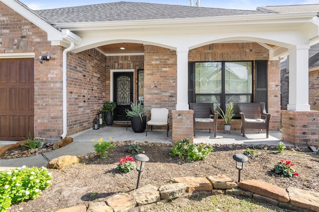 doorway to property with a garage and covered porch