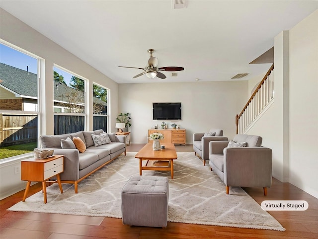 living room with ceiling fan and light hardwood / wood-style flooring