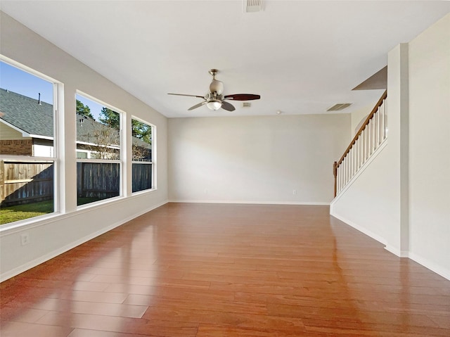 unfurnished room featuring hardwood / wood-style floors and ceiling fan