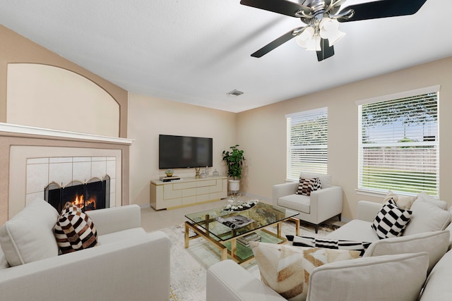 living room with a fireplace and ceiling fan