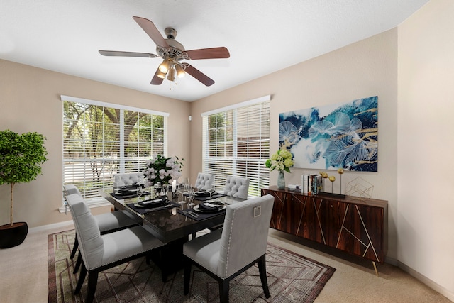 dining room featuring light carpet and ceiling fan