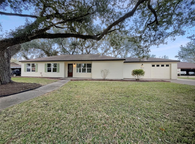 ranch-style home with a garage and a front lawn