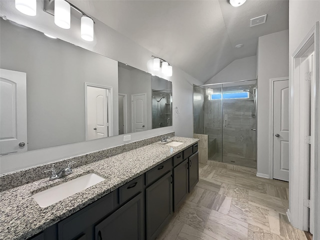 bathroom featuring vanity, an enclosed shower, and vaulted ceiling