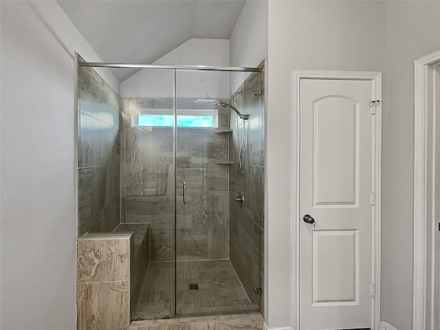 bathroom with lofted ceiling and an enclosed shower