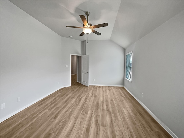 empty room featuring light wood-type flooring, ceiling fan, and lofted ceiling