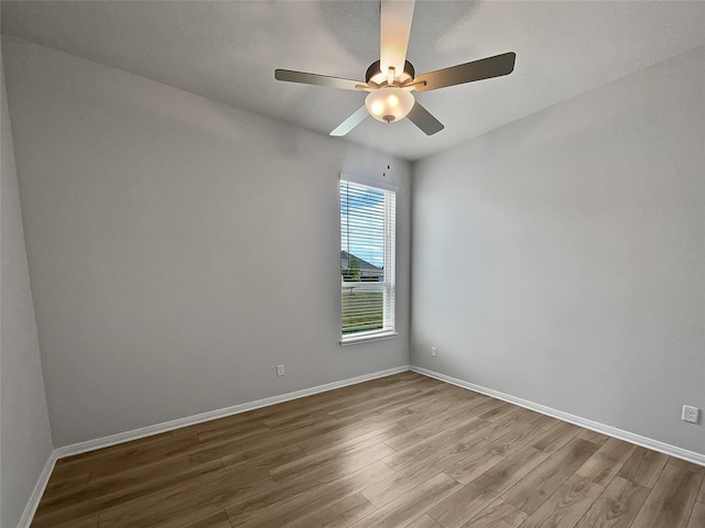 spare room featuring hardwood / wood-style flooring and ceiling fan