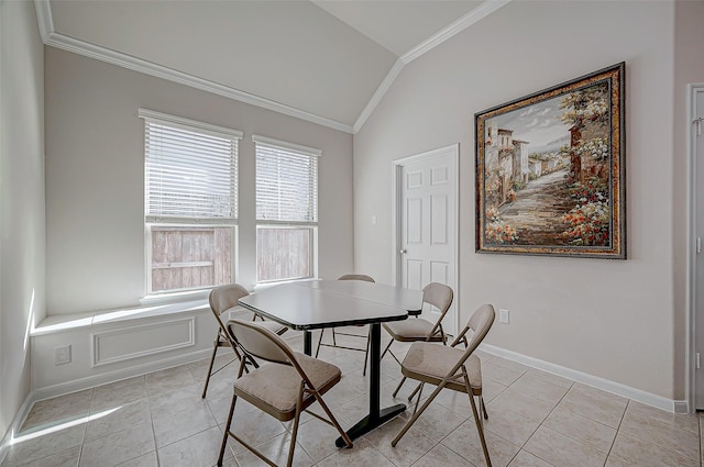 tiled dining area featuring crown molding and lofted ceiling