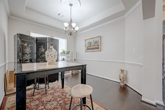 home office featuring dark hardwood / wood-style floors, a chandelier, and a tray ceiling