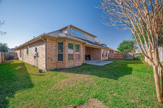 rear view of property with a patio area and a lawn