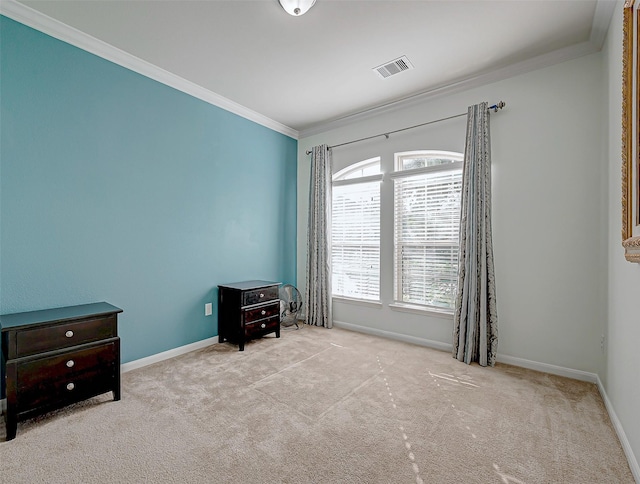 interior space with ornamental molding and light colored carpet