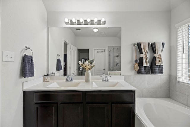 bathroom with vanity and separate shower and tub