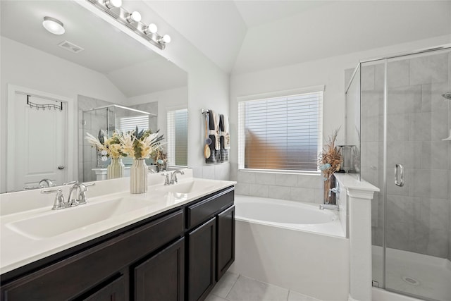 bathroom featuring tile patterned floors, vanity, separate shower and tub, and vaulted ceiling