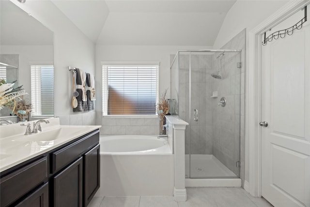 bathroom with tile patterned flooring, a wealth of natural light, and vaulted ceiling