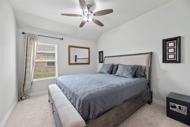 carpeted bedroom with ceiling fan and vaulted ceiling