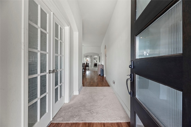 corridor with french doors and dark carpet