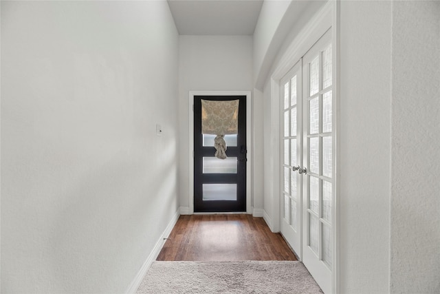 doorway featuring french doors and dark colored carpet