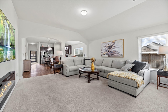 living room with carpet flooring and vaulted ceiling