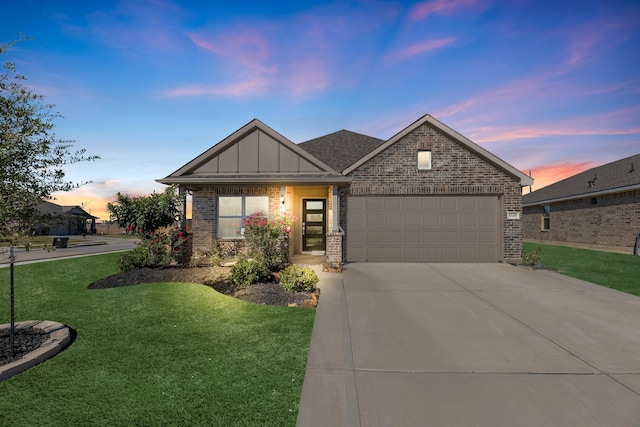 view of front facade with a yard and a garage